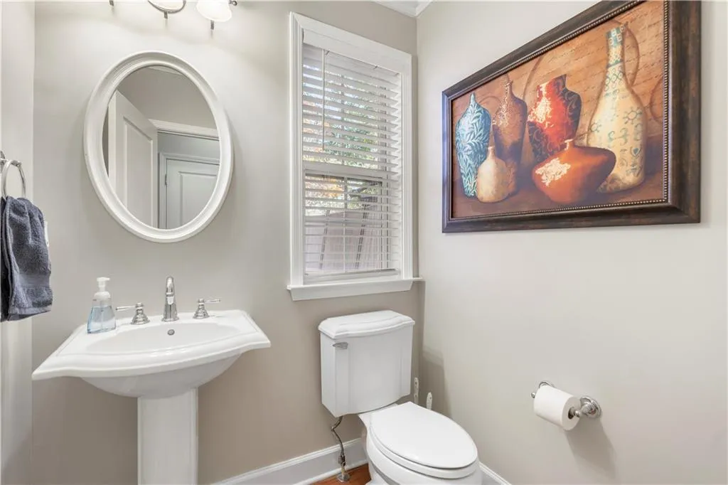 Half bathroom featuring baseboards and toilet