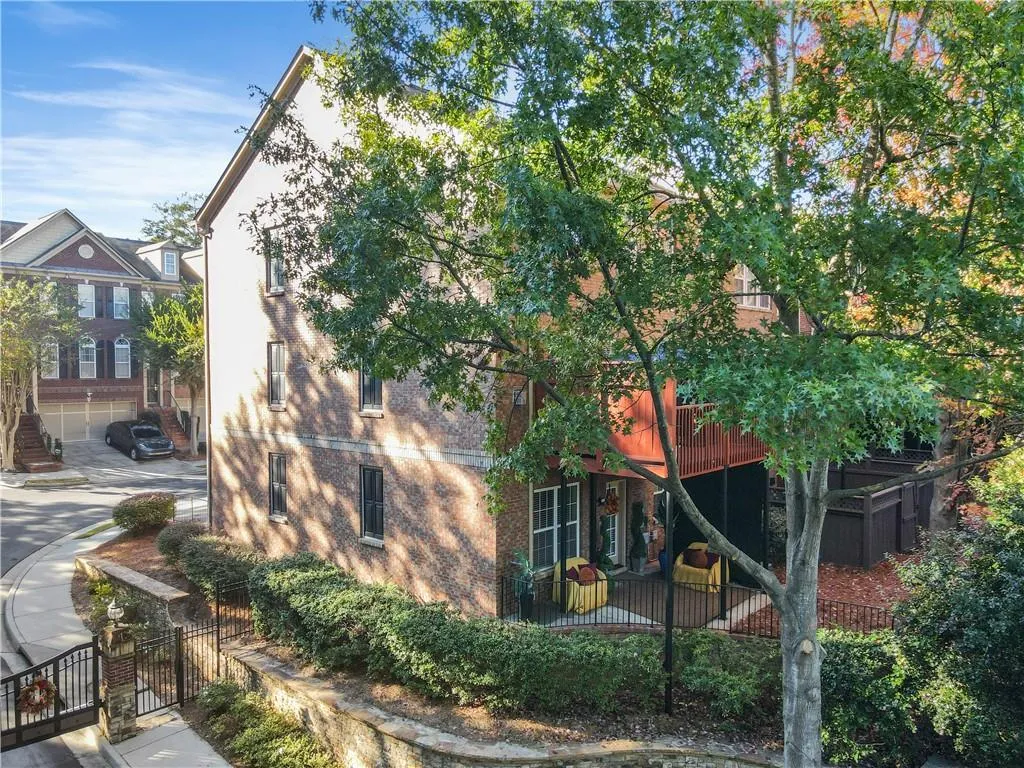 View of home's exterior featuring a gate and brick siding
