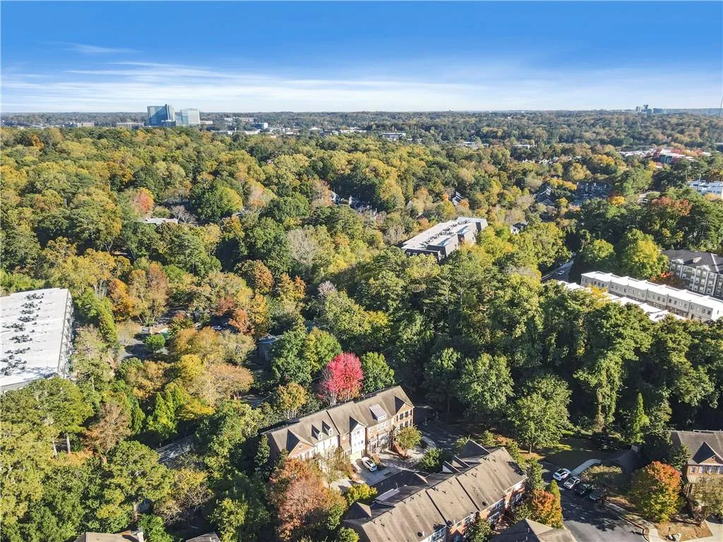 View of property location with a heavily wooded area