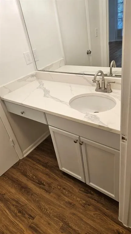 Bathroom with vanity and dark wood-type flooring