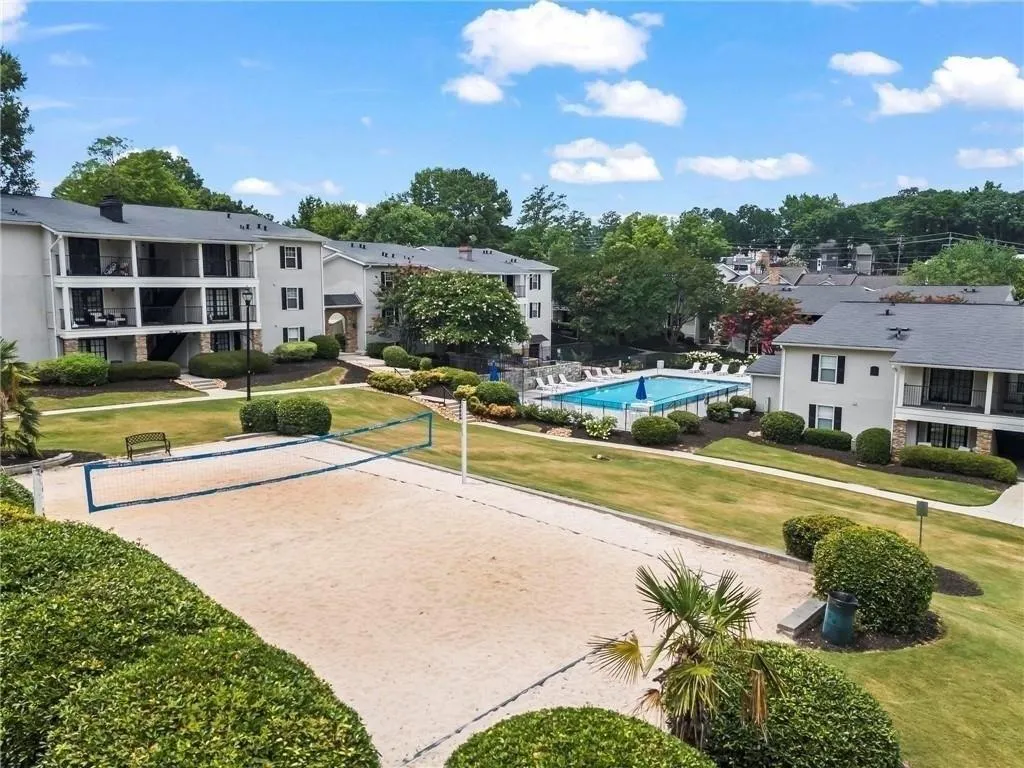 Surrounding community with volleyball court and a lawn