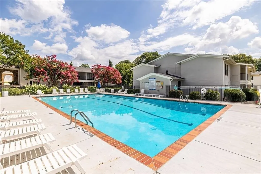 Community pool with a patio
