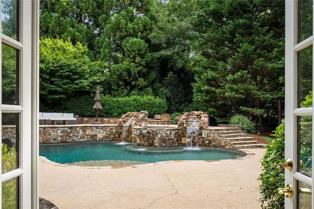 Resort style heated salt water pool with raised spa and waterfalls