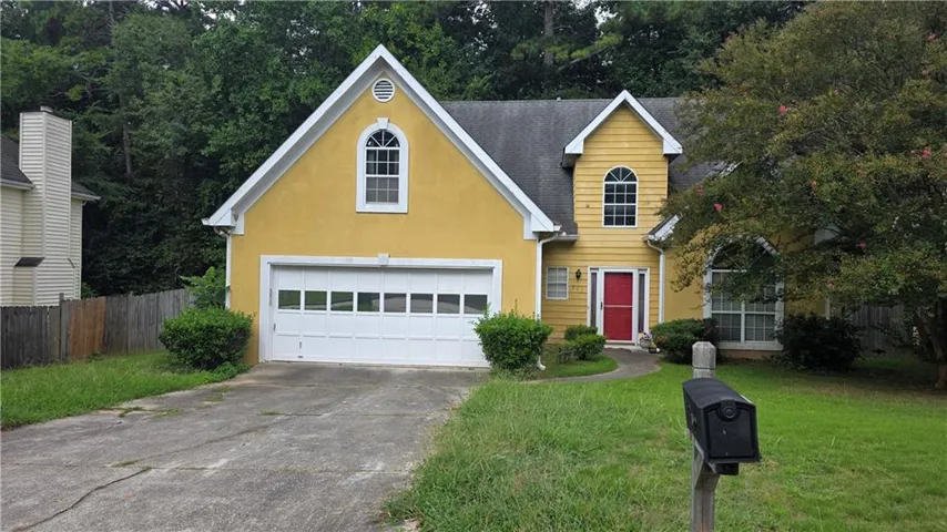 Yellow exterior with a red front door