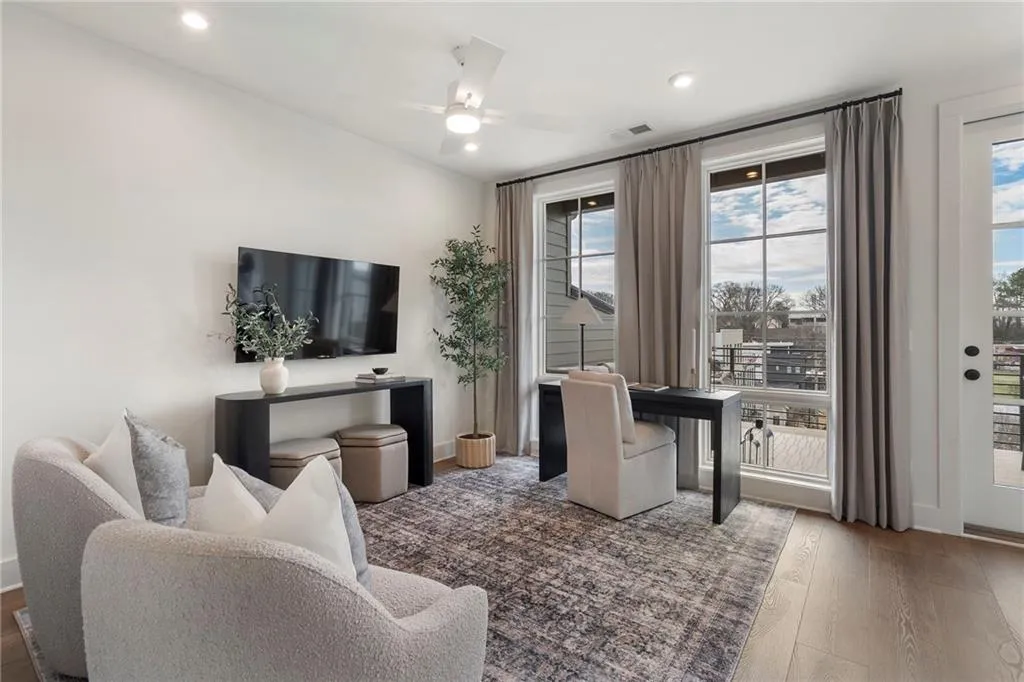 Living area featuring hardwood / wood-style floors, a ceiling fan, and recessed lighting
