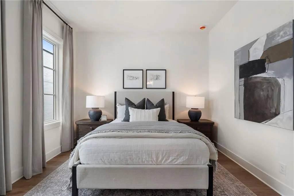 Bedroom with baseboards and wood finished floors