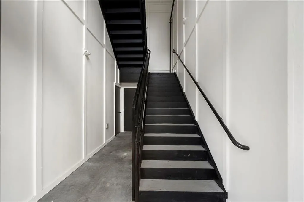 Staircase featuring concrete floors