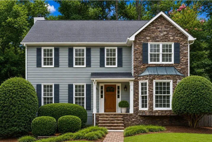 Two-story residence featuring a mixed-material facade with stone accents and horizontal siding