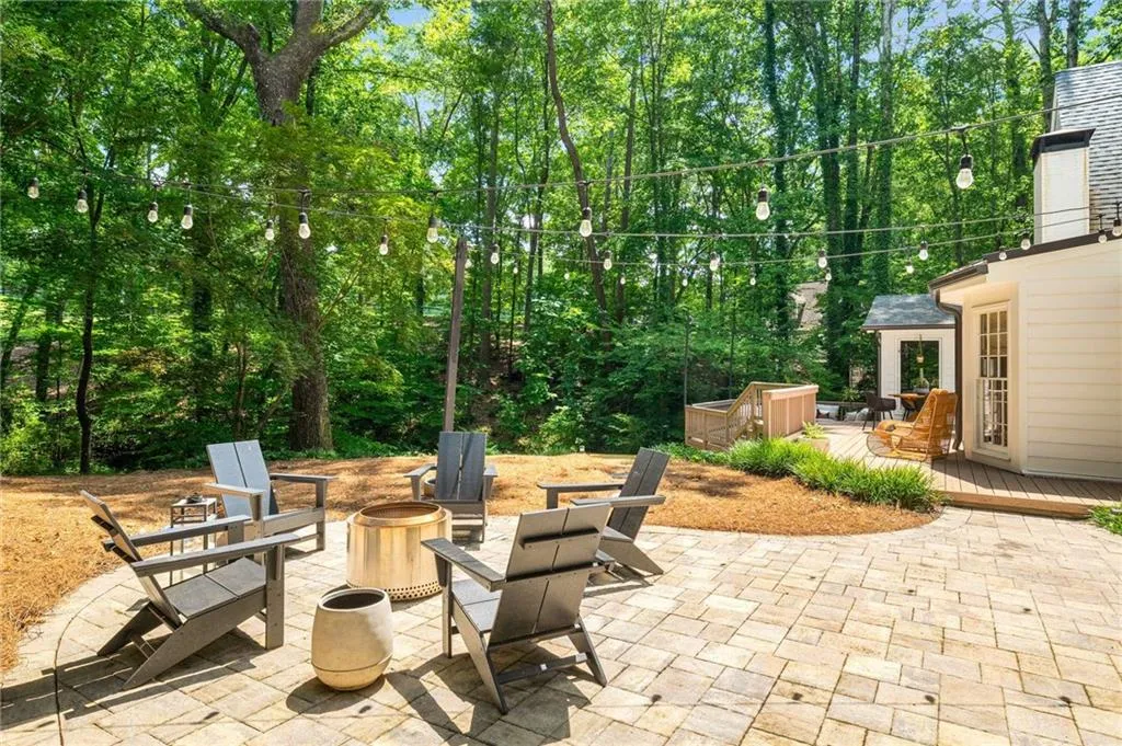 View of patio with a fire pit and a wooden deck