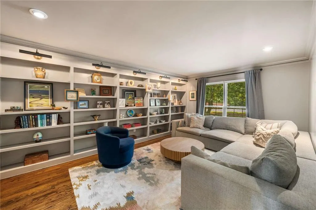 Living area featuring wood finished floors and ornamental molding