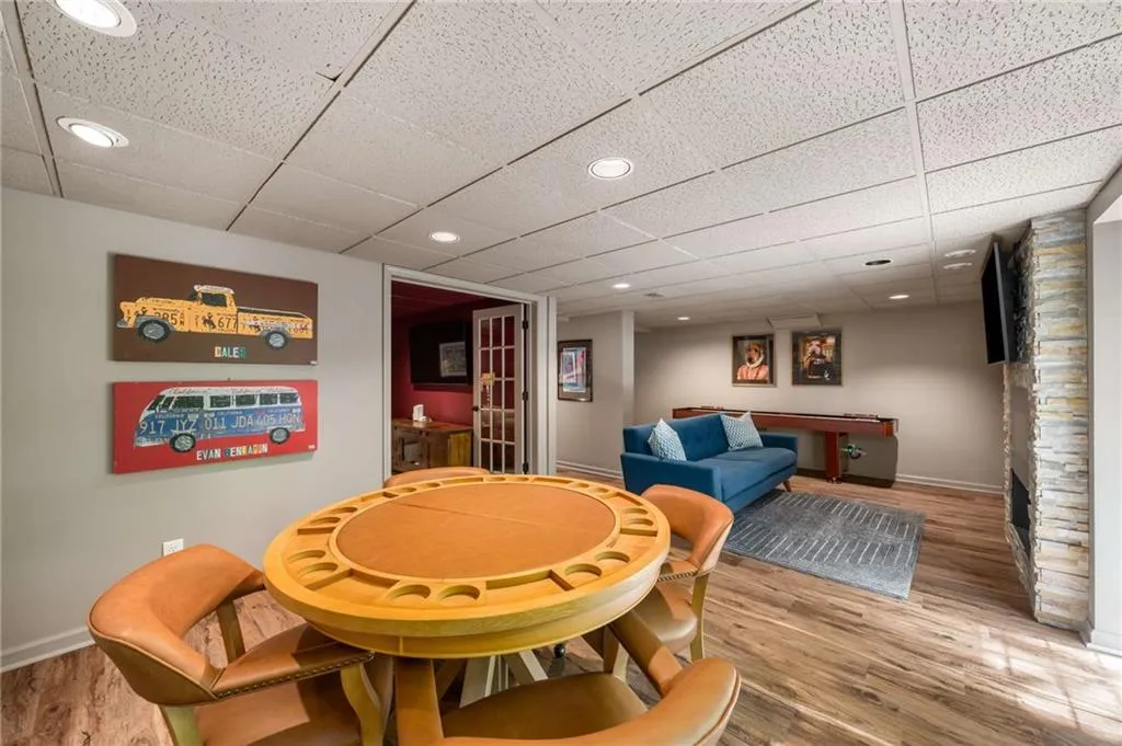 Dining space with wood finished floors, a paneled ceiling, and recessed lighting