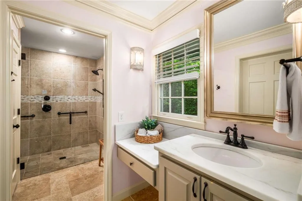 Full bath on First Floor featuring crown molding, vanity, a tile shower, and recessed lighting