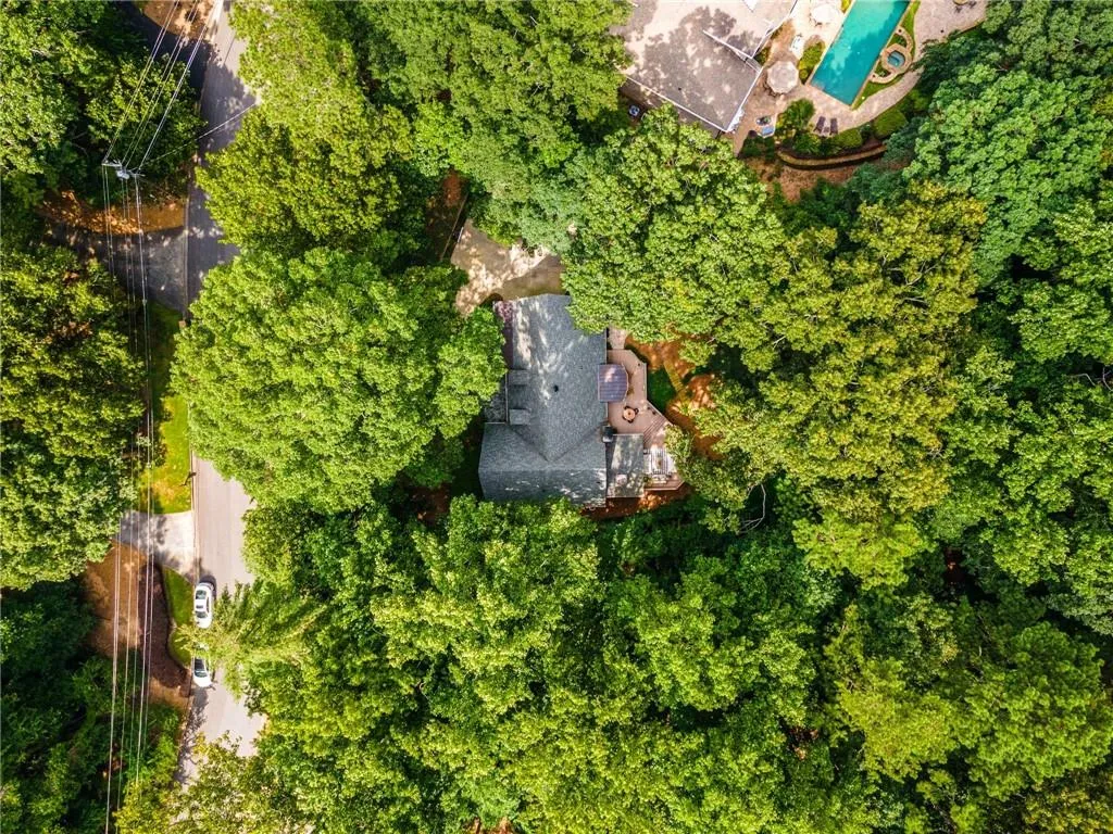 Aerial view of property and surrounding area featuring a pool area