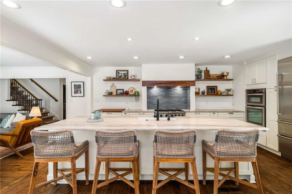 Kitchen with open shelves, white cabinetry, light stone countertops, dark wood-style flooring, and recessed lighting