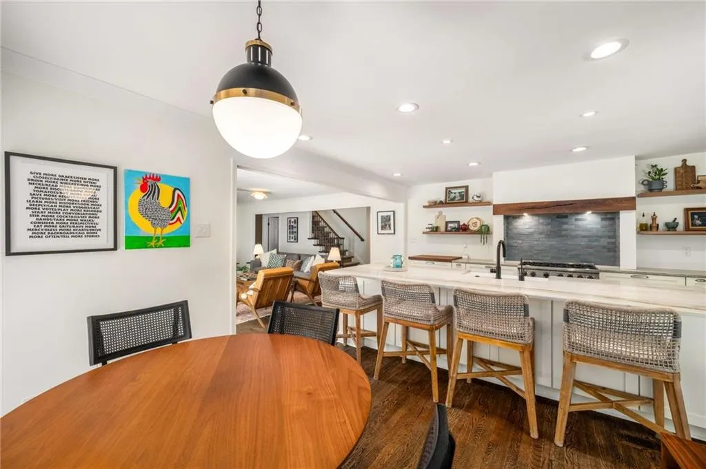 Dining space featuring stairway, wood finished floors, and recessed lighting