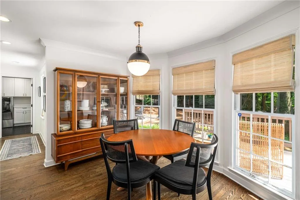 Dining area with dark wood-style floors, recessed lighting, and crown molding