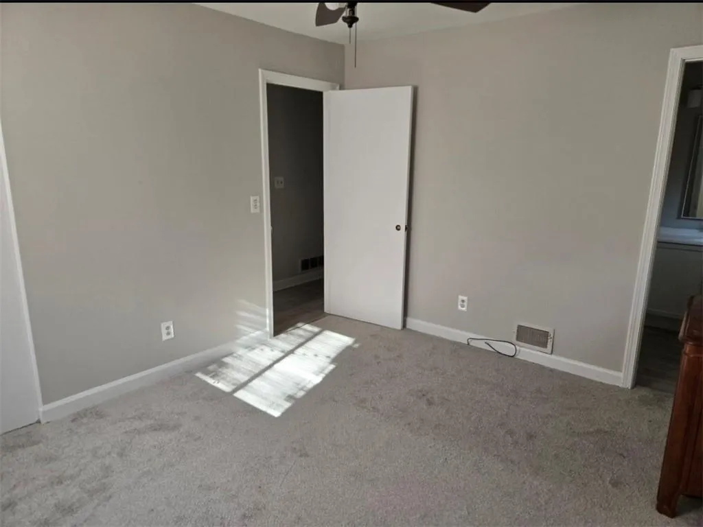 Unfurnished bedroom featuring carpet and ceiling fan