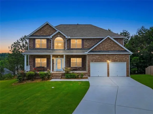 Traditional two-story brick residence with an arched window accent