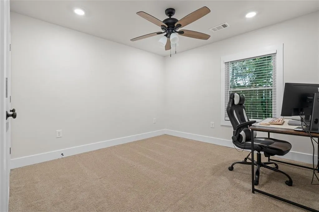 Office area with light carpet, recessed lighting, and a ceiling fan