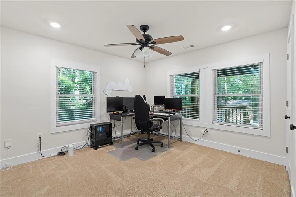 Carpeted home office with recessed lighting and a ceiling fan