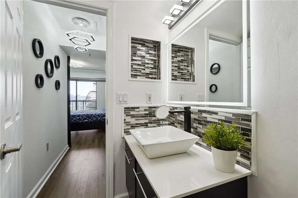 Bathroom with tasteful backsplash, a textured ceiling, vanity, and hardwood / wood-style floors