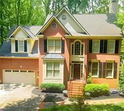 Stucco exterior with multiple gables and dormer windows