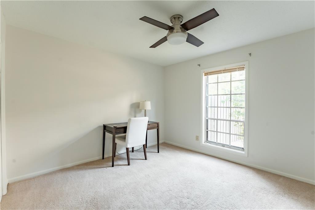 Office area featuring ceiling fan and light carpet
