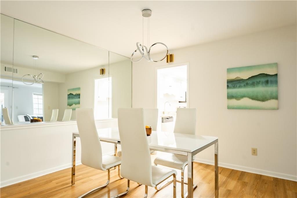 Dining space featuring light hardwood / wood-style floors and a notable chandelier