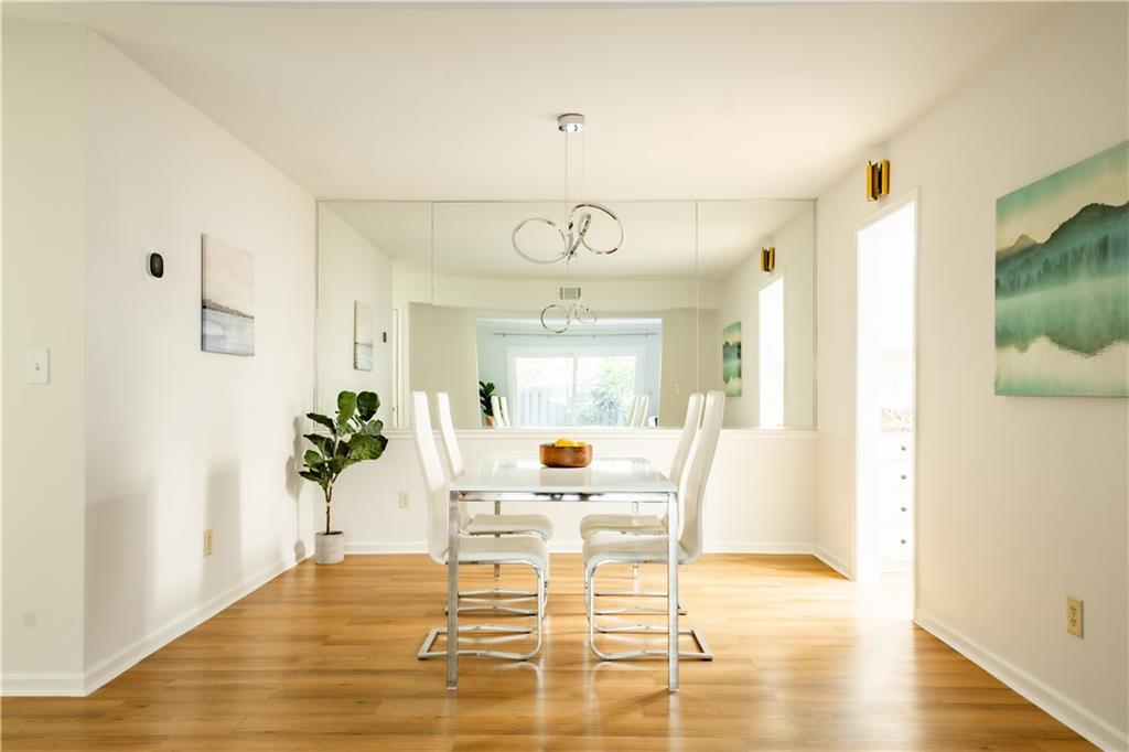 Dining area featuring light hardwood / wood-style floors and an inviting chandelier