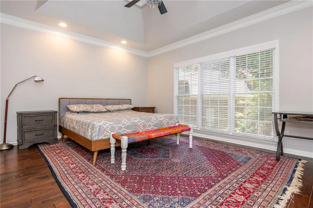 Bedroom featuring ornamental molding, dark wood finished floors, recessed lighting, and ceiling fan