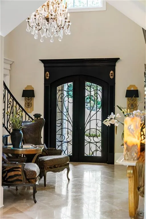 Entryway featuring high vaulted ceiling and a chandelier