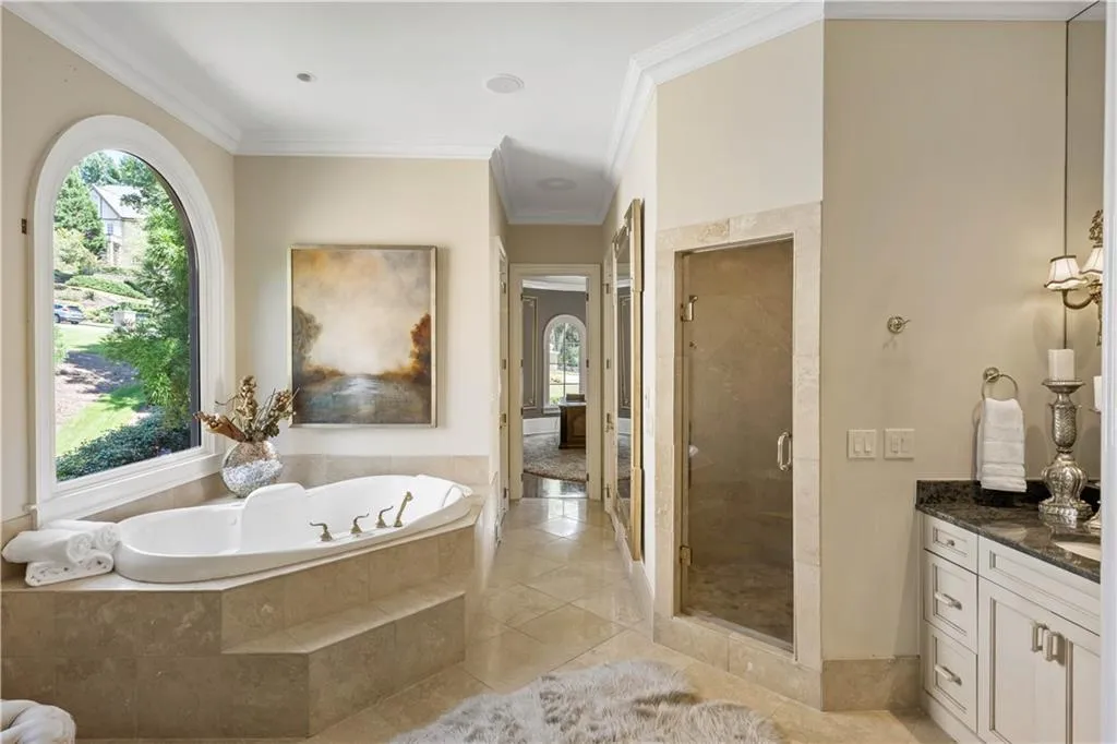 Bathroom featuring crown molding, vanity, independent shower and bath, and tile patterned flooring