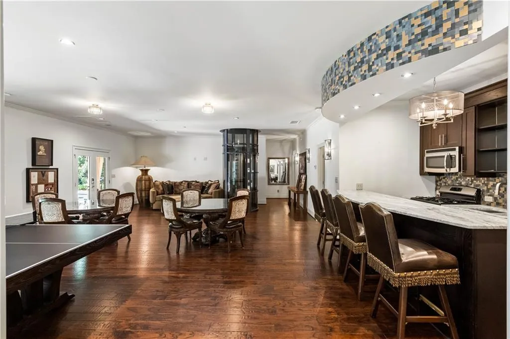 Dining space with dark hardwood / wood-style floors and a chandelier