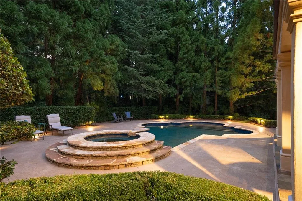 View of swimming pool featuring an in ground hot tub and a patio area