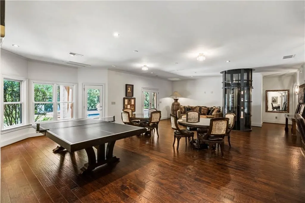 Game room featuring dark wood-type flooring