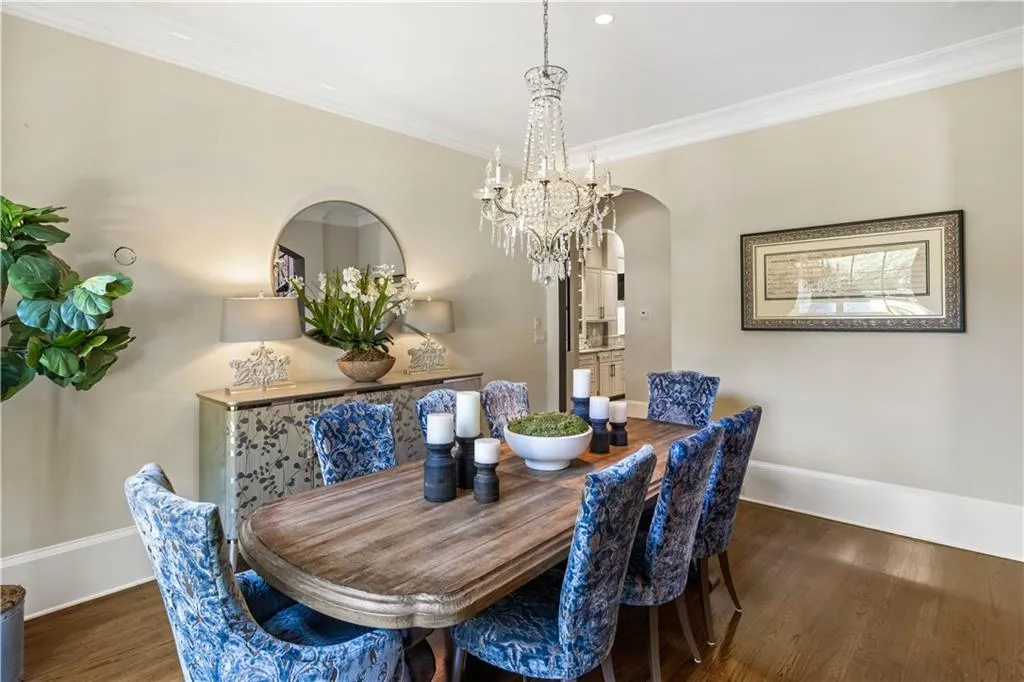 Dining area featuring ornamental molding, dark hardwood / wood-style floors, and a chandelier