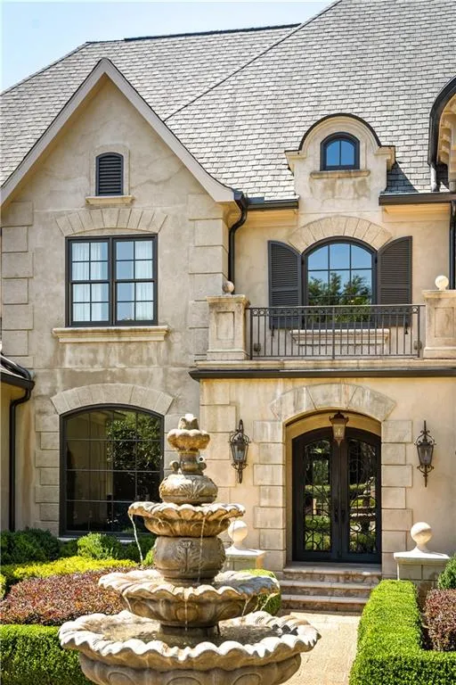 Doorway to property featuring a balcony and french doors