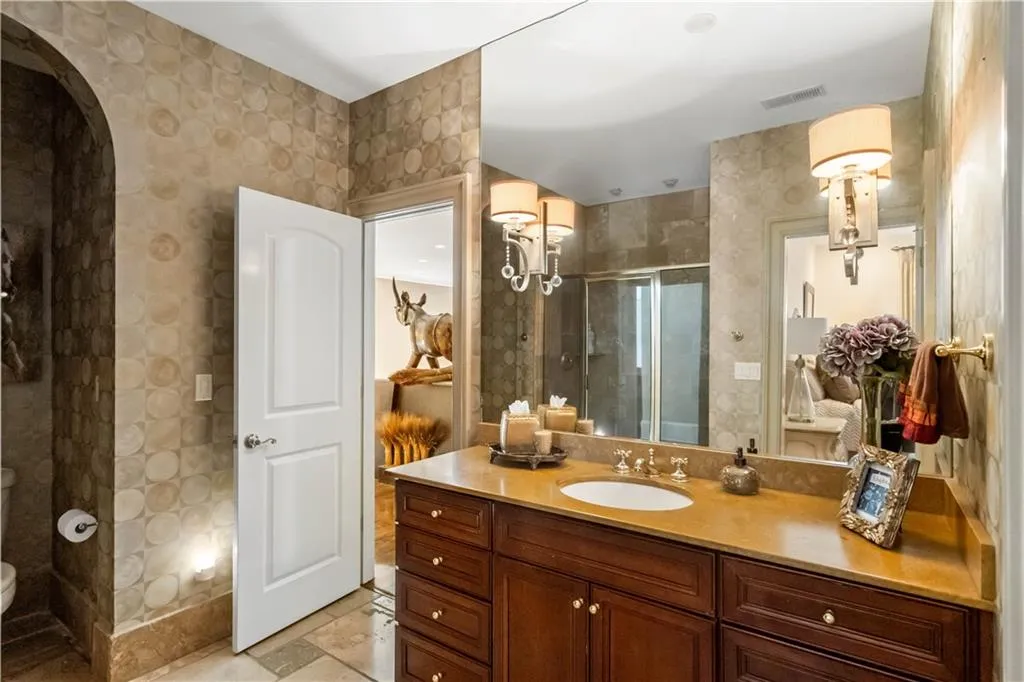 Bathroom with vanity, toilet, and a shower with door