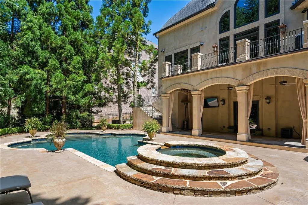 View of pool with a patio area and an in ground hot tub