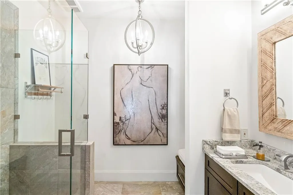 Bathroom featuring vanity, an enclosed shower, and a chandelier