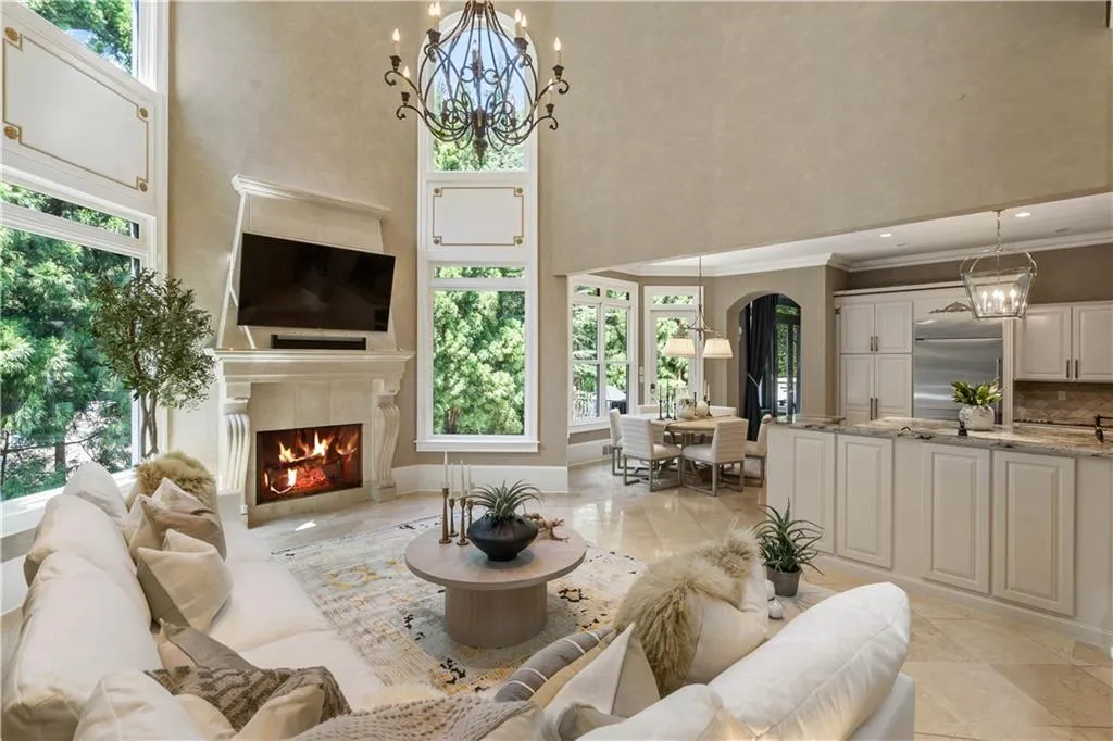 Living room featuring plenty of natural light and a notable chandelier