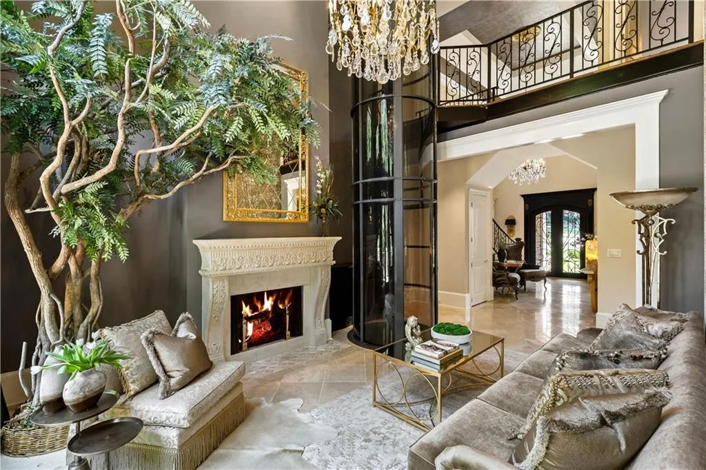 Living room with a notable chandelier and a towering ceiling