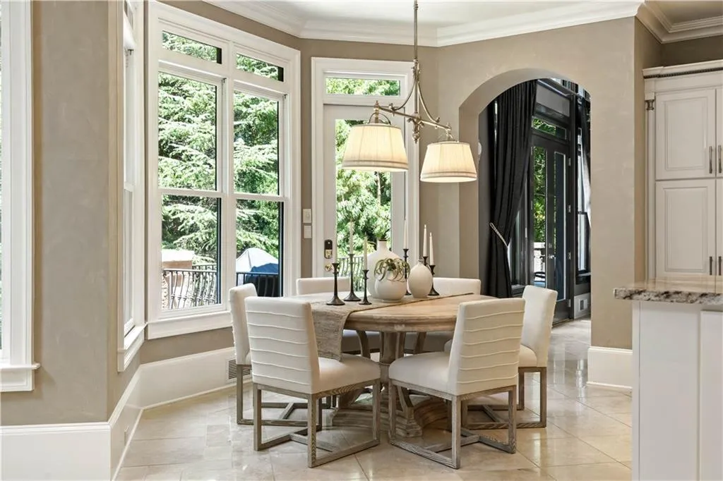 Tiled dining room featuring a notable chandelier and crown molding