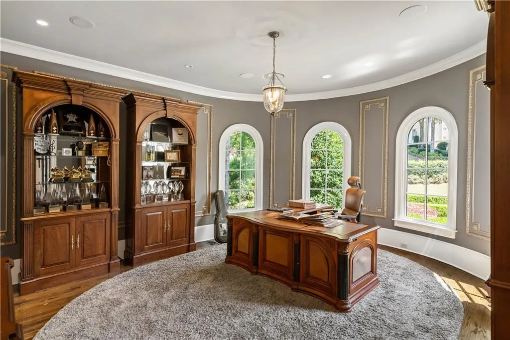 Home office with bar area, crown molding, and hardwood / wood-style flooring