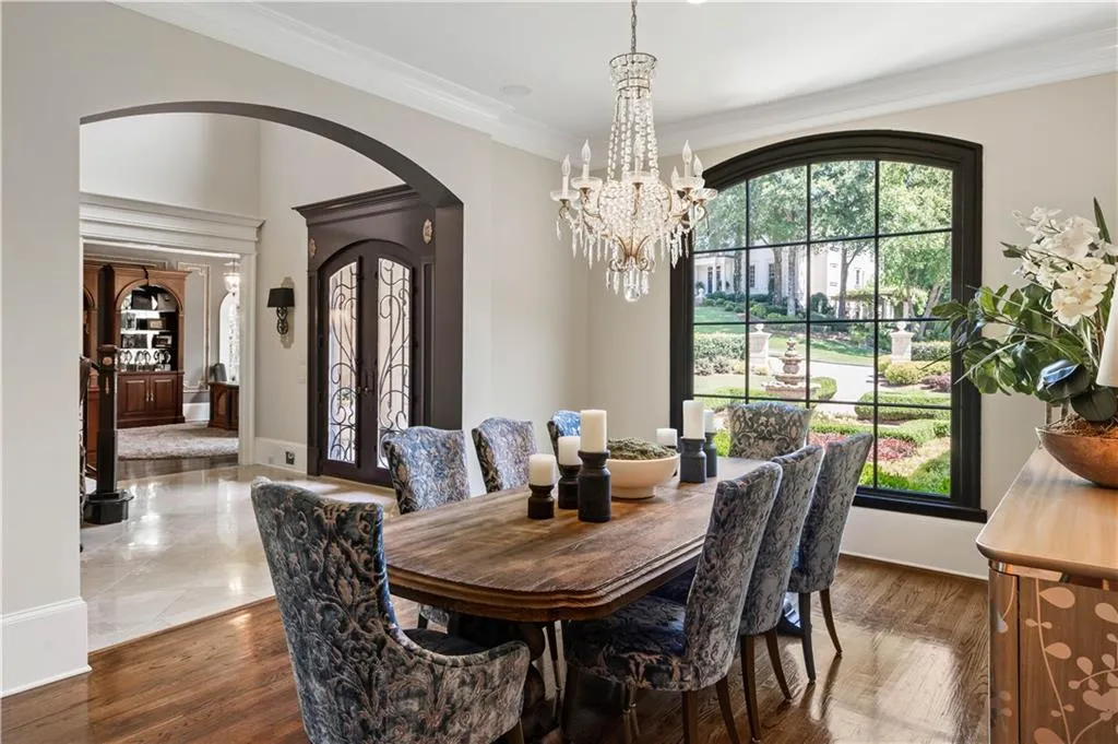 Dining room featuring crown molding, dark hardwood / wood-style flooring, a chandelier, and a wealth of natural light
