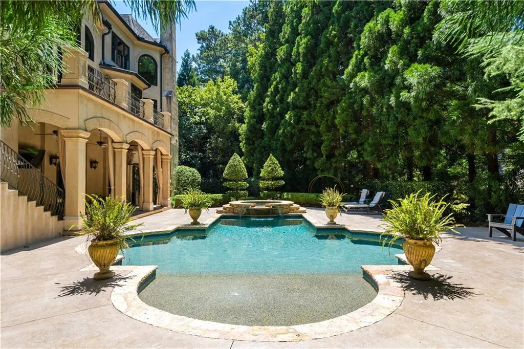View of pool with an in ground hot tub and a patio