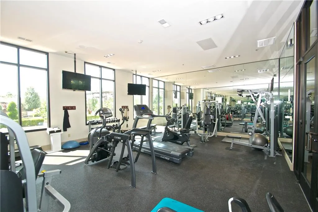 Workout area featuring visible TV's