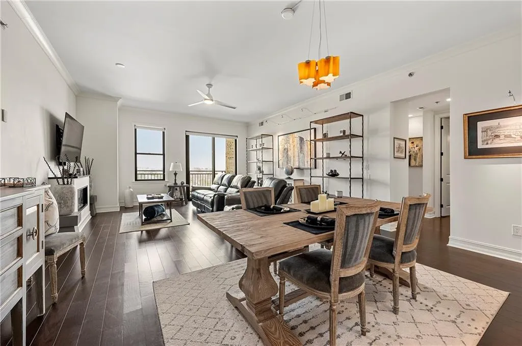 Dining area view featuring visible vents, baseboards, dark wood finished floors, and crown molding