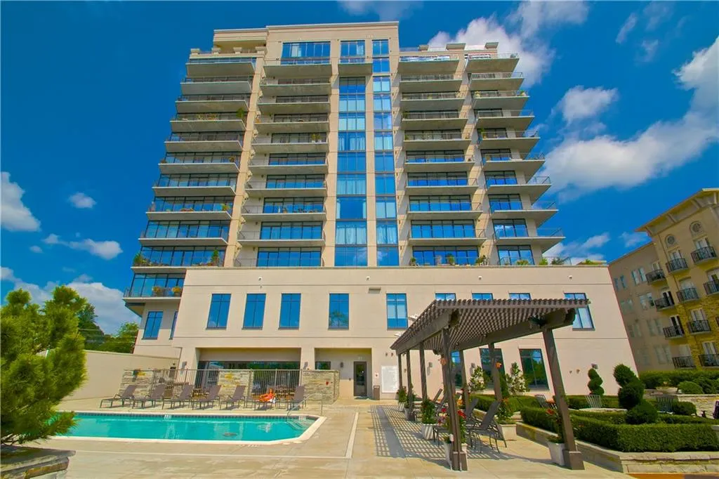 Pool with a patio, a pergola, and fence