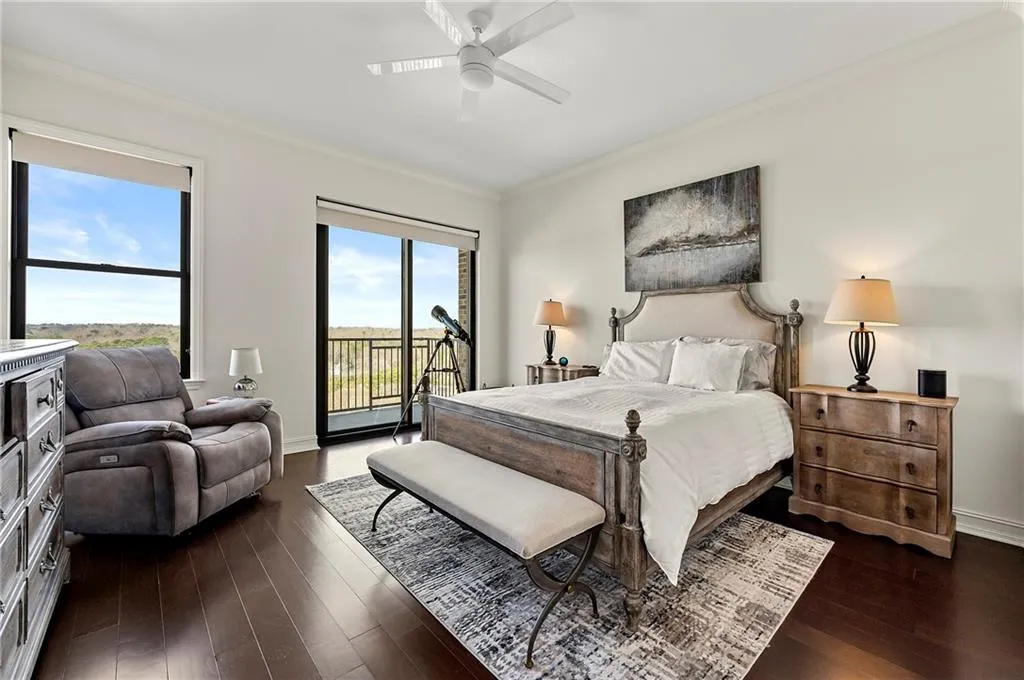 Primary Bedroom featuring dark wood flooring, ornamental molding, a ceiling fan, access to outside, and baseboards